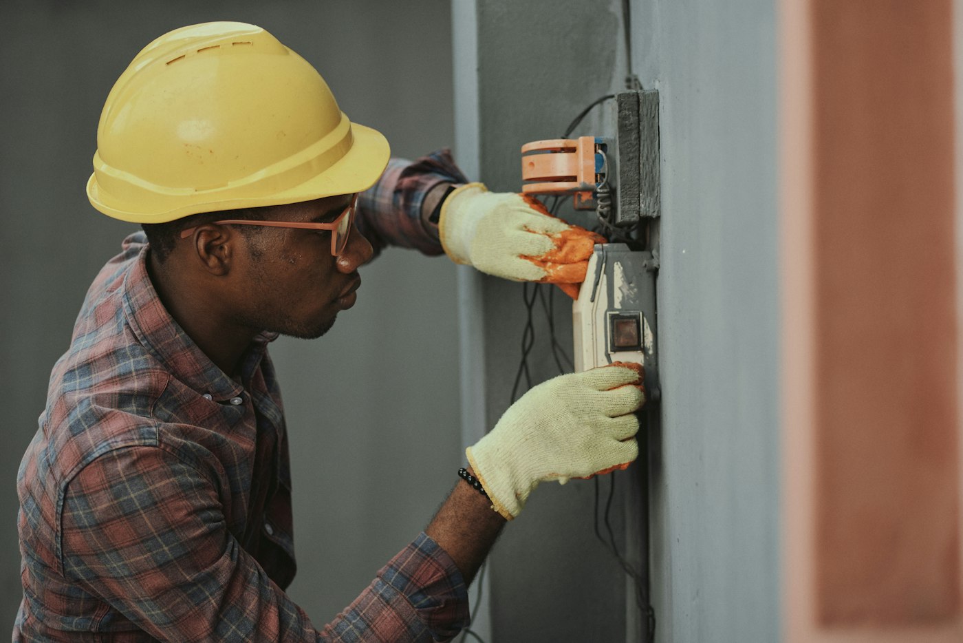 Electrician working on an industrial breaker panel